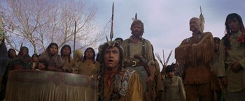 Movie still from “Jeremiah Johnson” (1972), directed by Sydney Pollack – A group of people in native american garb and headdresses; Medium shot, Low angle