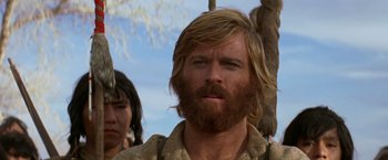 Movie still from “Jeremiah Johnson” (1972), directed by Sydney Pollack – A person with long hair and a beard; Close Up shot, Low angle