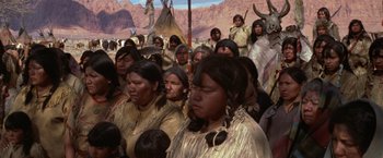 Movie still from “Jeremiah Johnson” (1972), directed by Sydney Pollack – A group of native american people gathered together; Wide shot, High angle