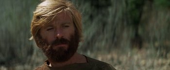 Movie still from “Jeremiah Johnson” (1972), directed by Sydney Pollack – A person with long hair and a beard; Close Up shot, Low angle