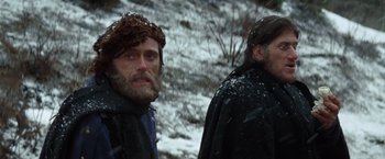 Movie still from “Jeremiah Johnson” (1972), directed by Sydney Pollack – Two men standing next to each other in the snow; Close Up shot, Low angle