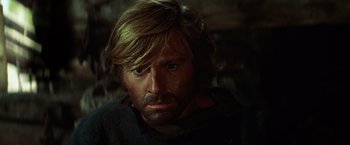 Movie still from “Jeremiah Johnson” (1972), directed by Sydney Pollack – A person with long blonde hair; Close Up shot, High angle