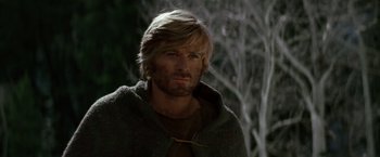 Movie still from “Jeremiah Johnson” (1972), directed by Sydney Pollack – A person with long hair and a beard; Close Up shot, Over the shoulder angle