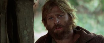 Movie still from “Jeremiah Johnson” (1972), directed by Sydney Pollack – A person with long hair and a beard; Close Up shot, Low angle