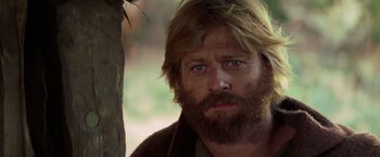 Movie still from “Jeremiah Johnson” (1972), directed by Sydney Pollack – A person with long hair and a beard; Close Up shot, Low angle