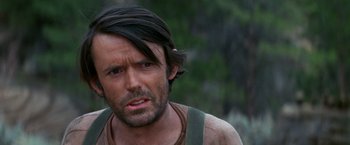 Movie still from “Jeremiah Johnson” (1972), directed by Sydney Pollack – A person with long black hair; Close Up shot, Over the shoulder angle