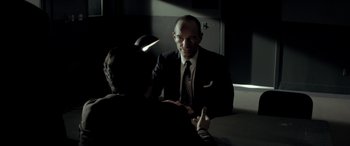 Movie still from “Jersey Boys” (2014), directed by Clint Eastwood – A man wearing a suit and tie talking to a woman; Medium shot, Over the shoulder angle