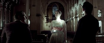 Movie still from “Jersey Boys” (2014), directed by Clint Eastwood – A woman holding a flashlight in a room; Medium shot, Low angle