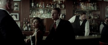 Movie still from “Jersey Boys” (2014), directed by Clint Eastwood – A man and a woman sitting at a bar; Medium shot, Low angle