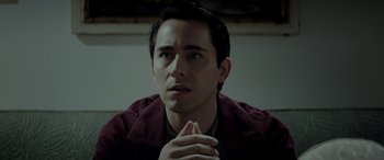 Movie still from “Jersey Boys” (2014), directed by Clint Eastwood – A man with his hands clasped together looking at the camera; Close Up shot, High angle