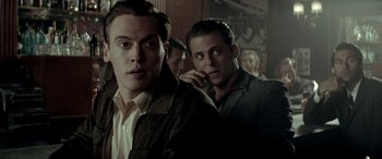 Movie still from “Jersey Boys” (2014), directed by Clint Eastwood – Two men are standing next to each other in a room; Close Up shot, Over the shoulder angle