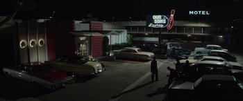 Movie still from “Jersey Boys” (2014), directed by Clint Eastwood – A couple of men standing on the side of a road; Extreme Wide shot, Low angle