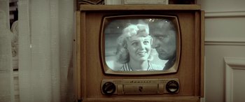 Movie still from “Jersey Boys” (2014), directed by Clint Eastwood – An old tv with a picture of a man and a woman on it; Extreme Close Up shot, Over the shoulder angle