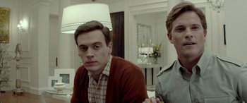 Movie still from “Jersey Boys” (2014), directed by Clint Eastwood – A man sitting next to another man in a living room; Close Up shot, Over the shoulder angle