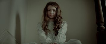 Movie still from “Jersey Boys” (2014), directed by Clint Eastwood – A young girl with long hair sitting in a room; Close Up shot, Low angle