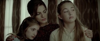 Movie still from “Jersey Boys” (2014), directed by Clint Eastwood – A woman and two young girls sitting next to each other; Close Up shot, High angle