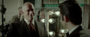 Movie still from “Jersey Boys” (2014), directed by Clint Eastwood – A man standing in front of a bathroom mirror; Close Up shot, Over the shoulder angle