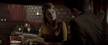 Movie still from “Jersey Boys” (2014), directed by Clint Eastwood – A woman sitting in front of a man at a table; Medium shot, Over the shoulder angle