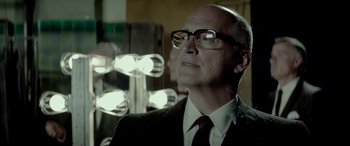 Movie still from “Jersey Boys” (2014), directed by Clint Eastwood – A man in a suit and tie looking out of a window; Close Up shot, Low angle