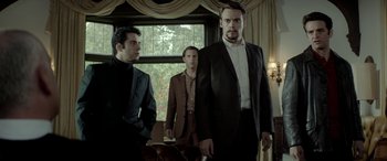 Movie still from “Jersey Boys” (2014), directed by Clint Eastwood – A group of men standing next to each other in front of a window; Medium shot, Low angle