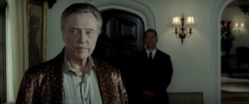 Movie still from “Jersey Boys” (2014), directed by Clint Eastwood – A man standing next to another man in front of a door; Close Up shot, Low angle