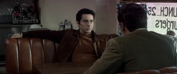 Movie still from “Jersey Boys” (2014), directed by Clint Eastwood – A man sitting in front of a mirror looking at himself in the mirror; Medium shot, Over the shoulder angle
