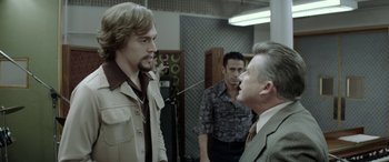 Movie still from “Jersey Boys” (2014), directed by Clint Eastwood – A group of men standing next to each other in a room; Medium shot, Over the shoulder angle