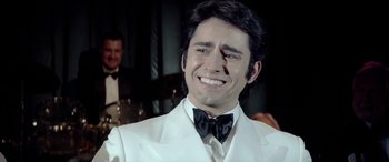 Movie still from “Jersey Boys” (2014), directed by Clint Eastwood – A person wearing a suit and a bow tie; Close Up shot, Over the shoulder angle