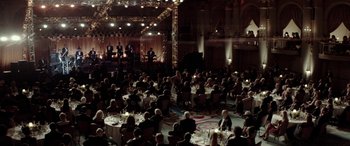 Movie still from “Jersey Boys” (2014), directed by Clint Eastwood – A group of people sitting at tables in front of a stage; Extreme Wide shot, High angle