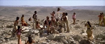 Movie still from “Jesus Christ Superstar” (1973), directed by Norman Jewison – A group of people sitting on top of a hill; Wide shot, High angle