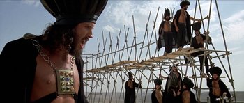 Movie still from “Jesus Christ Superstar” (1973), directed by Norman Jewison – A group of people standing on top of a wooden structure; Wide shot, Low angle