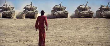 Movie still from “Jesus Christ Superstar” (1973), directed by Norman Jewison – A man standing in front of a group of tanks; Extreme Wide shot, Low angle