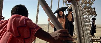 Movie still from “Jesus Christ Superstar” (1973), directed by Norman Jewison – A group of people standing next to each other on top of a hill; Medium shot, Low angle