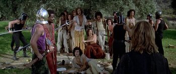 Movie still from “Jesus Christ Superstar” (1973), directed by Norman Jewison – A group of people standing and sitting in the grass; Wide shot, High angle