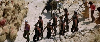 Movie still from “Jesus Christ Superstar” (1973), directed by Norman Jewison – A group of men in black shirts and black helmets are marching; Wide shot, High angle