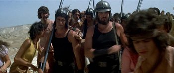 Movie still from “Jesus Christ Superstar” (1973), directed by Norman Jewison – A group of men wearing helmets and holding baseball bats; Medium shot, Low angle