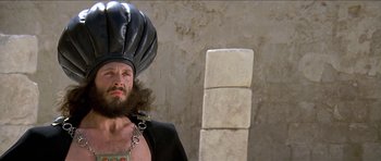 Movie still from “Jesus Christ Superstar” (1973), directed by Norman Jewison – A man with a beard wearing a black hat; Close Up shot, Low angle