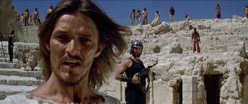 Movie still from “Jesus Christ Superstar” (1973), directed by Norman Jewison – A group of men standing on a cliff with guns in their hands; Close Up shot, Low angle