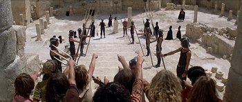 Movie still from “Jesus Christ Superstar” (1973), directed by Norman Jewison – A group of people standing in front of a crowd; Extreme Wide shot, High angle