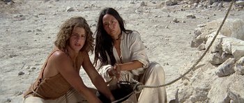 Movie still from “Jesus Christ Superstar” (1973), directed by Norman Jewison – Two women sitting on the ground with a rope; Medium shot, Low angle