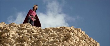 Movie still from “Jesus Christ Superstar” (1973), directed by Norman Jewison – A man standing on top of a pile of rocks; Wide shot, Low angle