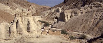 Movie still from “Jesus Christ Superstar” (1973), directed by Norman Jewison – People are walking on a path in the middle of the desert; Extreme Wide shot, High angle