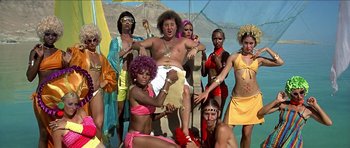 Movie still from “Jesus Christ Superstar” (1973), directed by Norman Jewison – A group of men and women dressed in costumes; Wide shot, Low angle