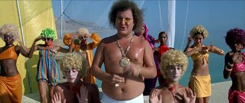 Movie still from “Jesus Christ Superstar” (1973), directed by Norman Jewison – A man in a white shirt and some people in wigs; Medium shot, Low angle