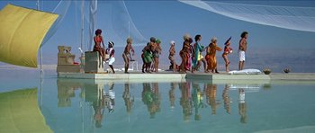 Movie still from “Jesus Christ Superstar” (1973), directed by Norman Jewison – A group of people standing next to a body of water; Extreme Wide shot, Low angle