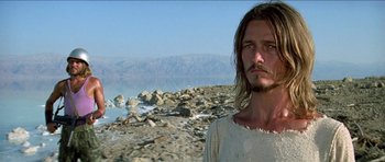 Movie still from “Jesus Christ Superstar” (1973), directed by Norman Jewison – A man standing on top of a rocky beach; Close Up shot, Low angle