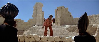 Movie still from “Jesus Christ Superstar” (1973), directed by Norman Jewison – A woman standing on a set of stairs; Wide shot, Low angle