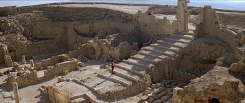 Movie still from “Jesus Christ Superstar” (1973), directed by Norman Jewison – A person standing on steps in an ancient ruins area; Extreme Wide shot, High angle
