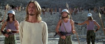 Movie still from “Jesus Christ Superstar” (1973), directed by Norman Jewison – A man in a white shirt and a man in a purple shirt; Medium shot, Low angle
