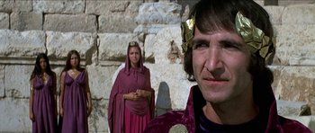Movie still from “Jesus Christ Superstar” (1973), directed by Norman Jewison – A man and a woman dressed in medieval garb in front of a stone wall; Close Up shot, Over the shoulder angle
